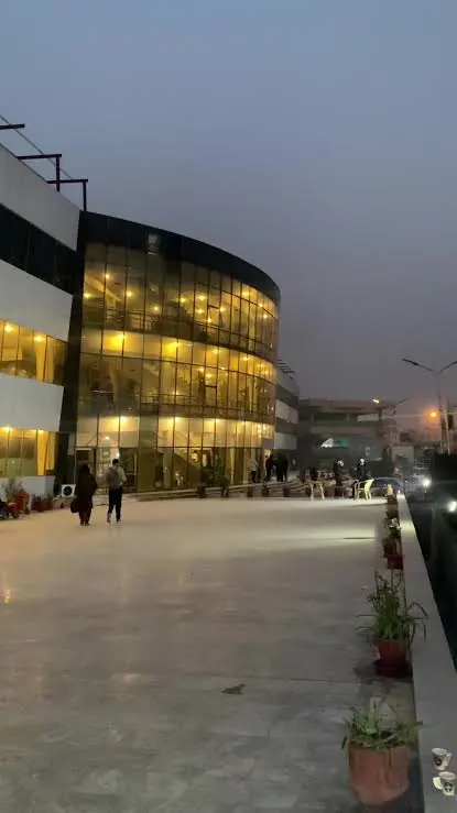 INU campus building at dusk overlooking the main plaza in Phase-2 Hayatabad, Peshawar