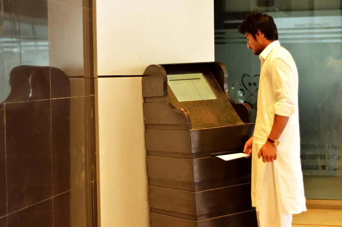 Student using the I-WIZ self-service kiosk in the INU lobby