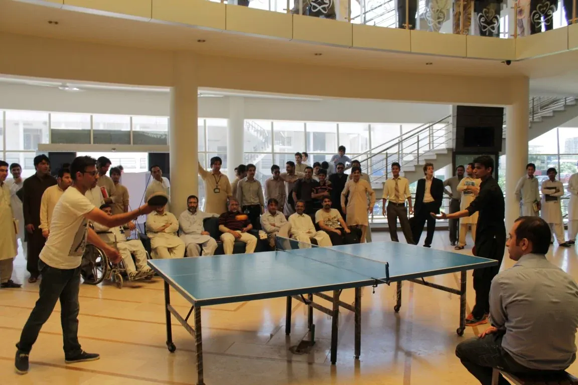 INU student serving during a table tennis game